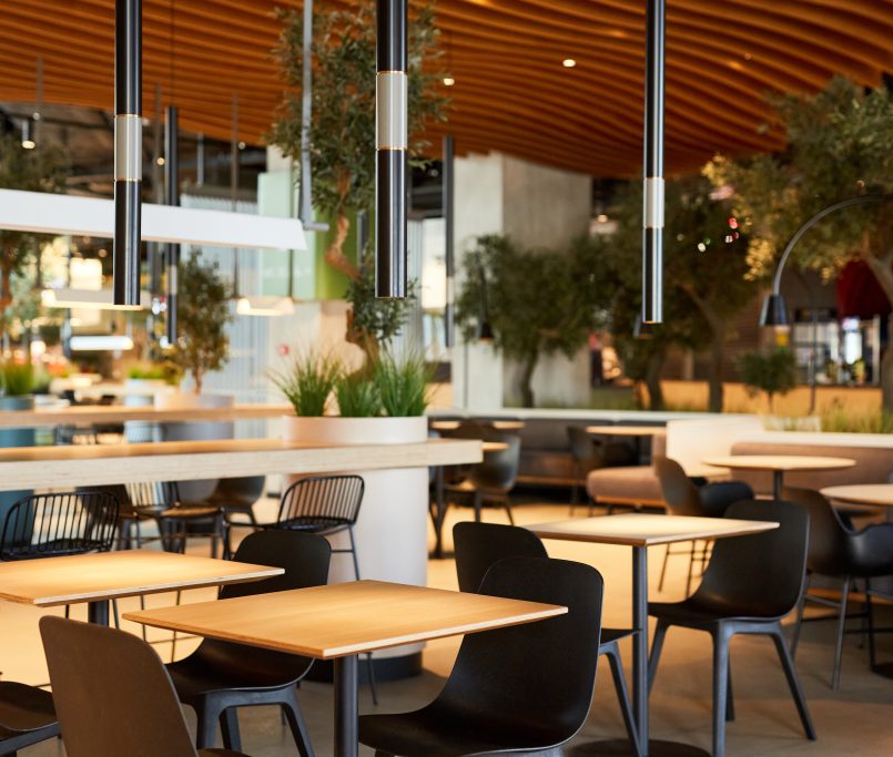 Background image of empty food court interior with wooden tables and warm cozy light setting, copy space